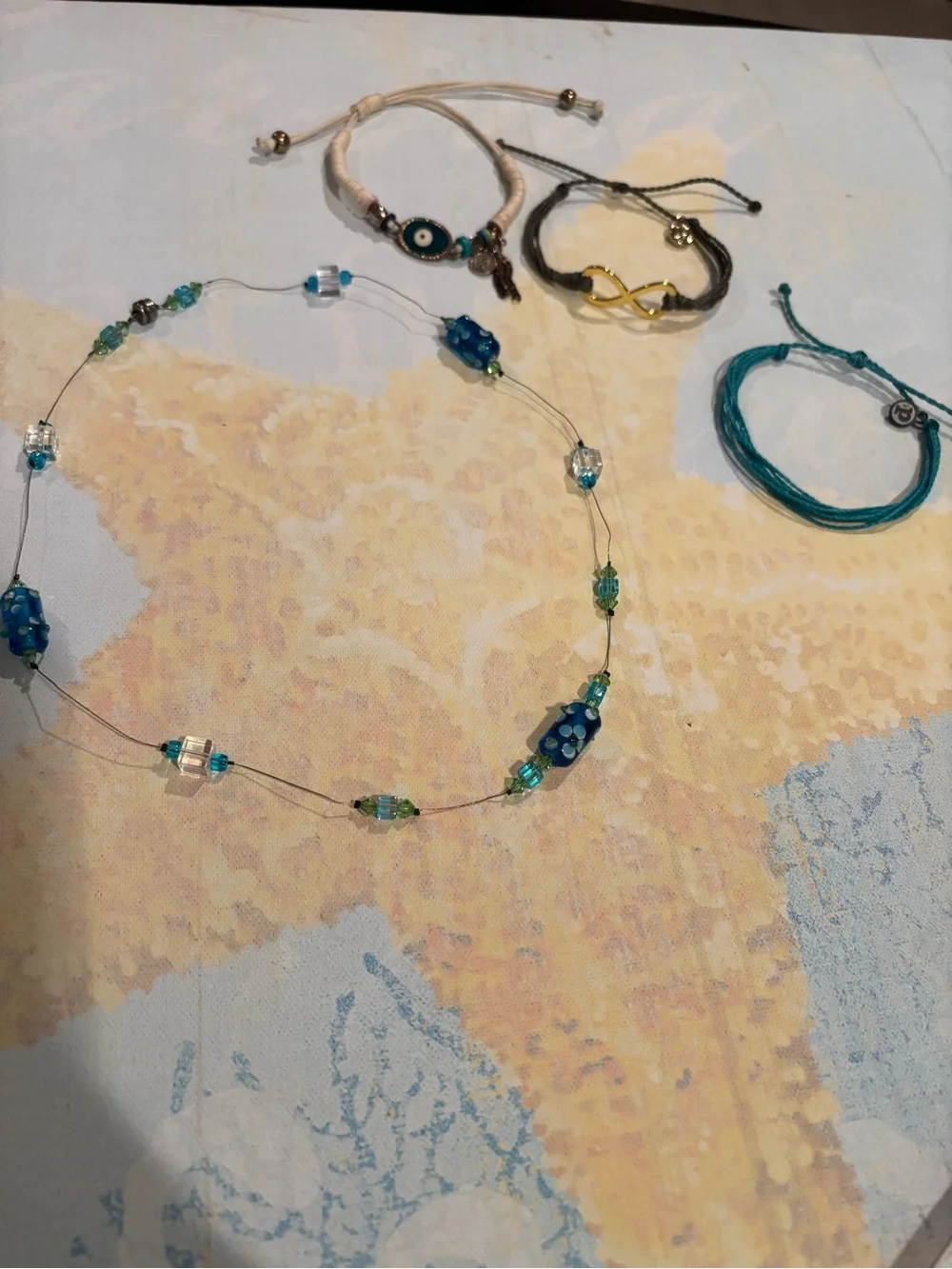 3 cord bracelets. 1 beaded Necklace. Pura Vida and evil eye bracelet. $18.00